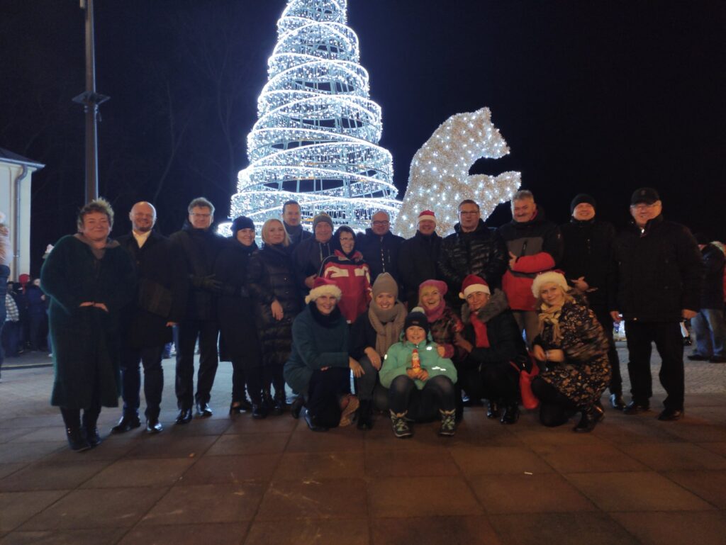 Grupowe zdjęcie samorządu Aleksandrowa Łódzkiego na tle ozdób świątecznych 
